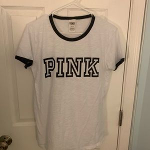 White shirt with black lettering from pink